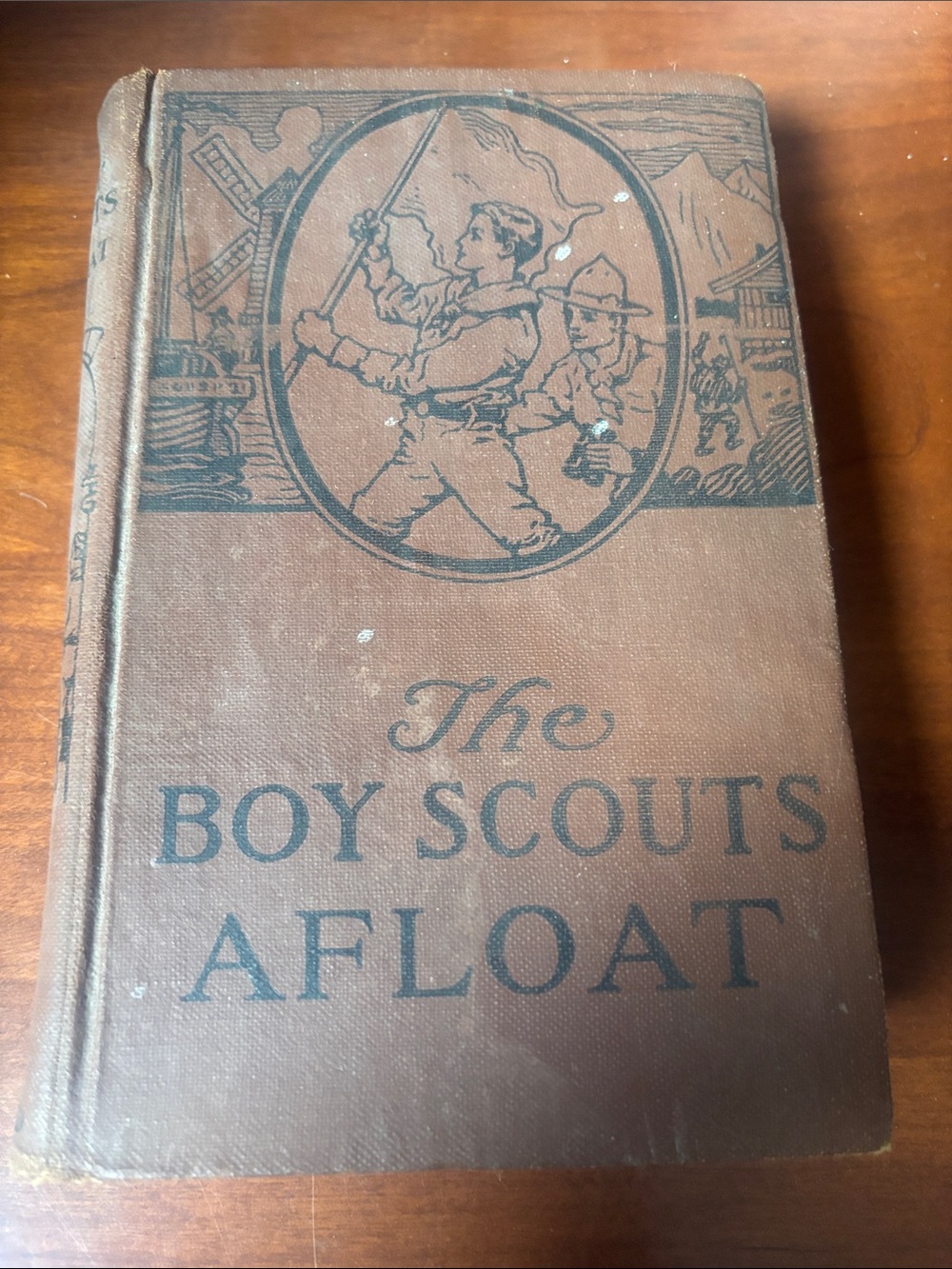 is "The Boy Scouts Afloat," published by The Saalfield Publishing Co. in 1921